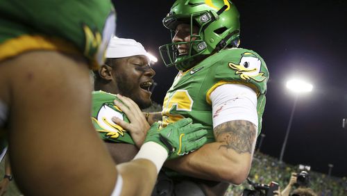 Oregon place kicker Atticus Sappington (36) is congratulated by teammates after his game-winning field goal after an NCAA college football game against Boise State, Saturday, Sept. 7, 2024, at Autzen Stadium in Eugene, Ore. (AP Photo/Lydia Ely)