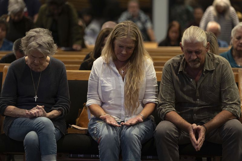 Audience members pray with Pastor Jack Hibbs at a Comeback California Tour event at Revival Fellowship, Saturday, Sept. 21, 2024, in Menifee, Calif. (AP Photo/Zoë Meyers)