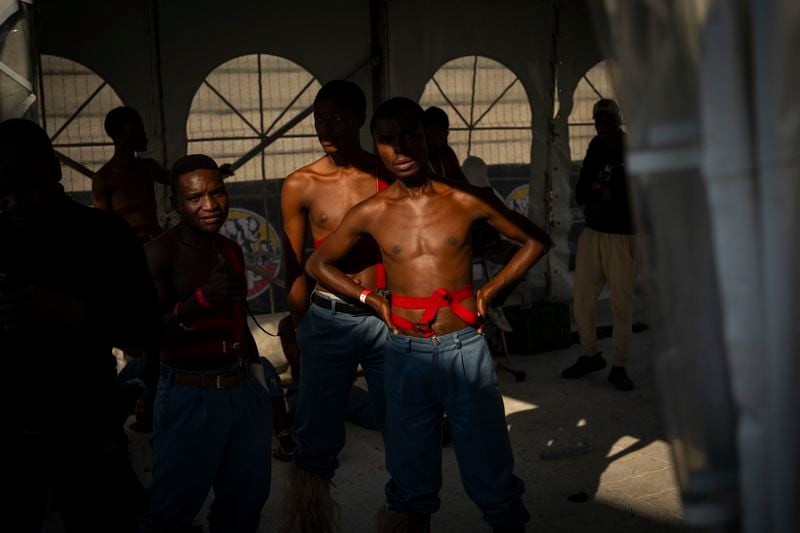 Dancers wait to take part in a performance during an election rally organized by Inkatha Freedom Party in Richards Bay, near Durban, South Africa, Sunday, May 26, 2024, in anticipation of the 2024 general elections scheduled for May 29. (AP Photo/Emilio Morenatti)