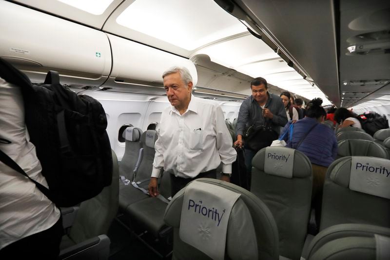FILE - Mexican President Andres Manuel Lopez Obrador deplanes after traveling in economy on a commercial flight from Guadalajara to Mexico City, March 9, 2019. Lopez Obrador swept into office with the motto laying out his administration’s priorities: “For the good of all, first the poor.” (AP Photo/Marco Ugarte, File)