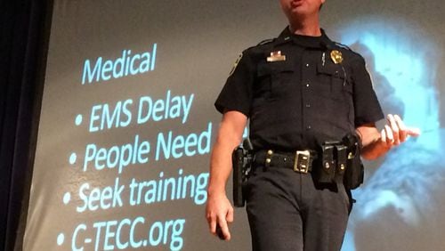 Lt. Brian Marshall of the Marietta Police Department addresses a crowd at Marietta Middle School. The department hosted a second seminar on how to react in an active shooting. MARK DAVIS/MRDAVIS@AJC.COM