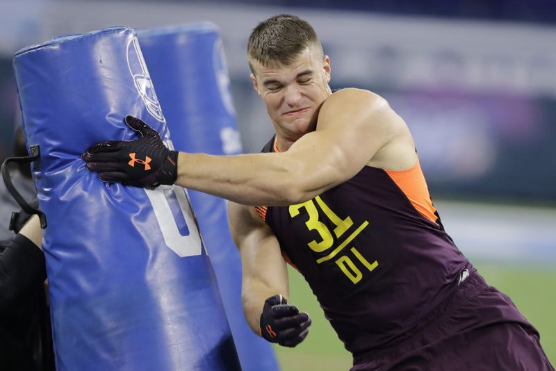 Charleston defensive lineman John Cominsky runs a drill during the NFL football scouting combine, Sunday, March 3, 2019, in Indianapolis. (AP Photo/Darron Cummings)