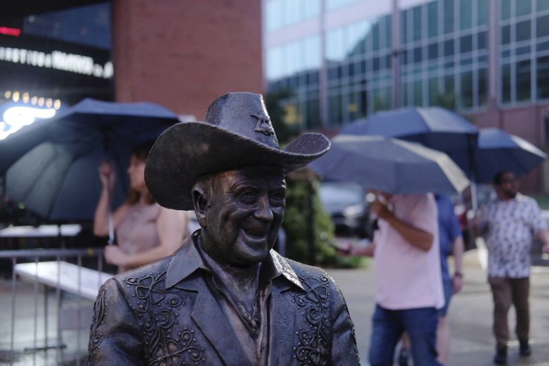 A statue of Grand Ole Opry star Little Jimmy Dickens is displayed outside the Ryman Auditorium in Nashville, Tenn., on July 30, 2024. (AP Photo/Luis Andres Henao)