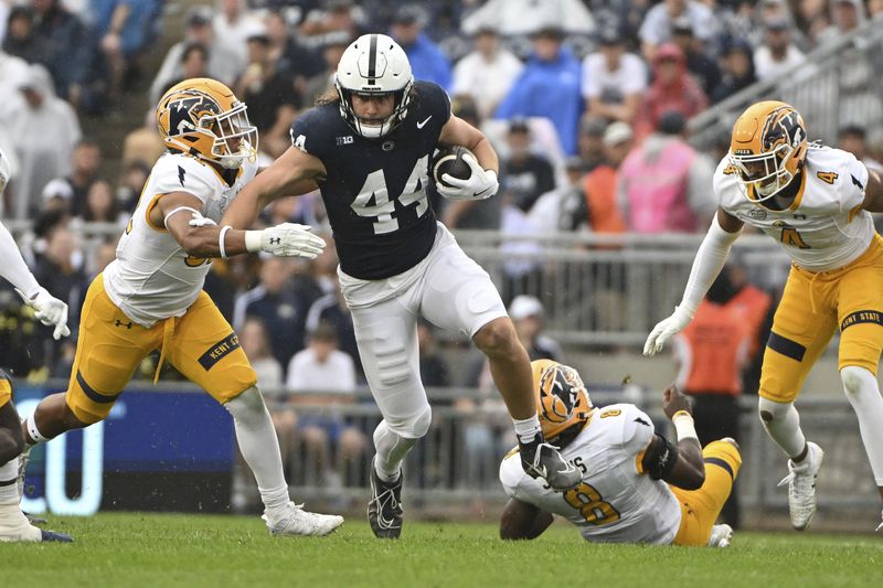 Penn State tight end Tyler Warren (44) gains yardage while being tackled by Kent State linebacker Jayden Studio, left, during the first quarter of an NCAA college football game, Saturday, Sept. 21, 2024, in State College, Pa. (AP Photo/Barry Reeger)