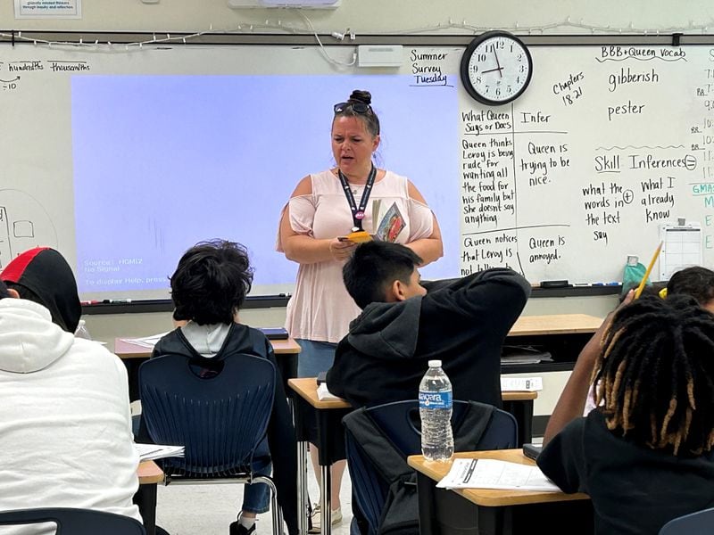 Jennifer Dallas reads a book with her fifth grade class at Heards Ferry Elementary School in Fulton County. She's teaching them to make inferences using a book called "The Broken Bike Boy and the Queen of 33rd Street." (Martha Dalton/martha.dalton@ajc.com)