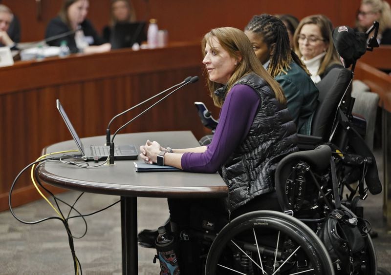Acworth resident Janet Paulsen, shown testifying in 2019, told a Senate panel that she would likely not be paralyzed if the protective order she took out on her estranged husband had prohibited him from owning a gun. Senate Bill 150 would make it illegal for convicted domestic abusers or anyone who is under a “family violence protective order” to possess firearms. BOB ANDRES / BANDRES@AJC.COM