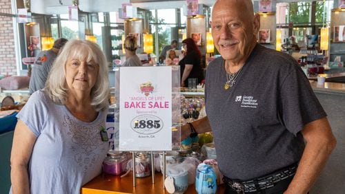 Two-time transplant recipient Lester E. Crowell Jr. (right) stands with his sister Sherry Weiss at a bake sale at the Three-13 Salon, Spa & Boutique in Marietta to raise funds for the Georgia Transplant Foundation. Crowell, who runs the salon, has spent 12 years hosting fundraising events for the organization. PHIL SKINNER FOR THE ATLANTA JOURNAL-CONSTITUTION