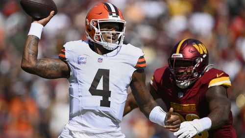 Cleveland Browns quarterback Deshaun Watson (4) looks to pass under pressure from Washington Commanders defensive tackle Phidarian Mathis (98) during the first half of an NFL football game in Landover, Md., Sunday, Oct. 6, 2024. (AP Photo/Nick Wass)