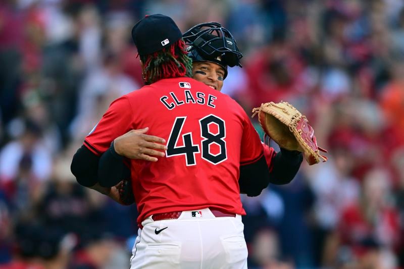 Cleveland Guardians catcher Bo Naylor, rear, hugs relief pitcher Emmanuel Clase (48) after the Guardians defeated the Detroit Tigers in Game 1 of baseball's AL Division Series, Saturday, Oct. 5, 2024, in Cleveland. (AP Photo/David Dermer)