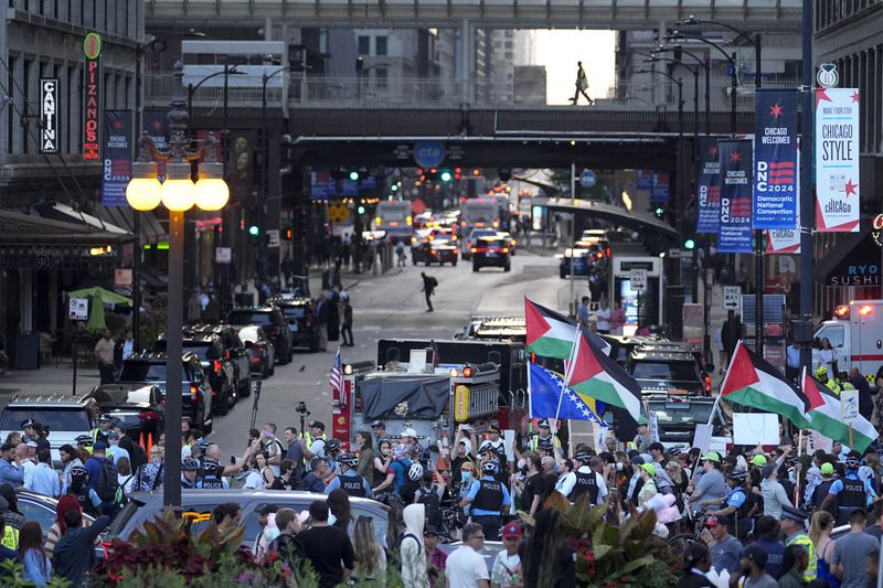 Protesters march prior to the start of the Democratic National Convention Sunday, Aug. 18, 2024, in Chicago. (AP Photo/Julio Cortez)