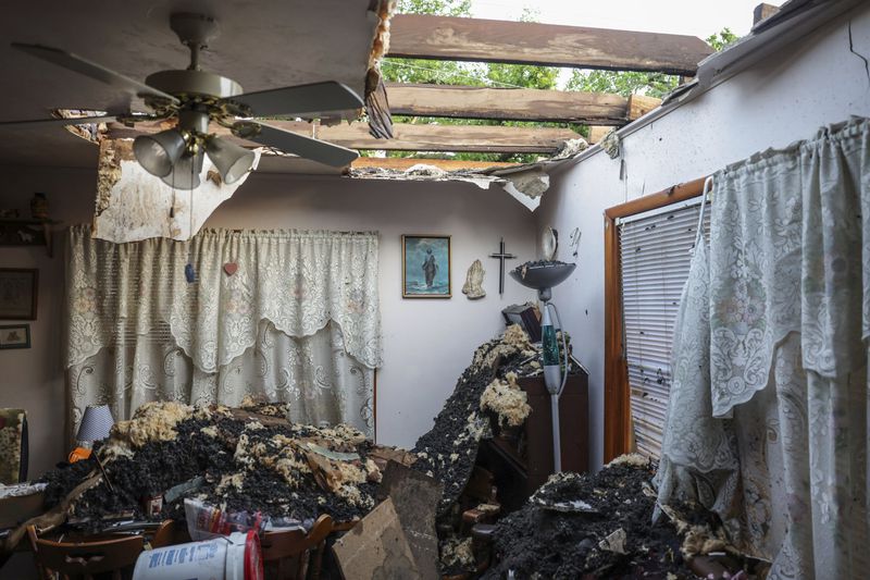 Damage is seen to Tom Jones' home after the roof blew off during a storm, Sunday, May 26, 2024, in Claremore, Okla. (Mike Simons/Tulsa World via AP)