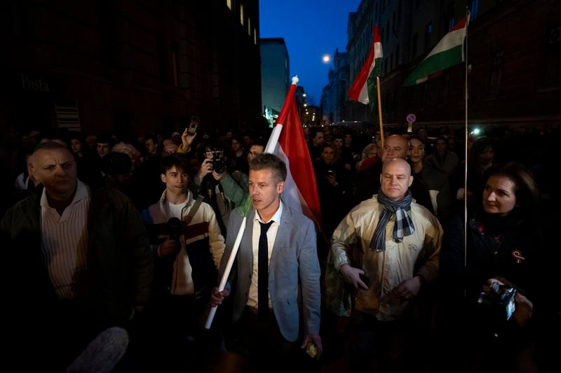 Former Hungarian government insider Péter Magyar, center, leads the crowd during a protest next to Kossuth Lajos Square in Budapest, Hungary, on March 26, 2024. Magyar, 43, seized on growing disenchantment with the populist Prime Minister Viktor Orbán, building a political movement that in only a matter of weeks looks poised to become Hungary's largest opposition force. (AP Photo/Denes Erdos)