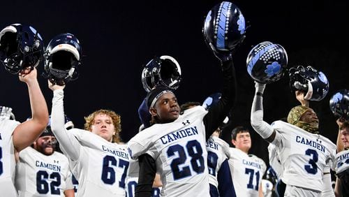 Camden County players salute their fans after beating McEachern 25-0 during a playoff game Friday, Nov. 17, 2023 at McEachern High School. (Daniel Varnado/For the AJC)