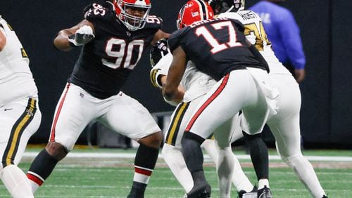 Atlanta Falcons linebacker Arnold Ebiketie (17) tackles New Orleans Saints quarterback Derek Carr (4) with Atlanta Falcons defensive tackle David Onyemata (90) during the second half of a NFL football game between the Atlanta Falcons and the New Orleans Saints in Atlanta on Sunday, Nov. 26, 2023.   (Bob Andres for the Atlanta Journal Constitution)