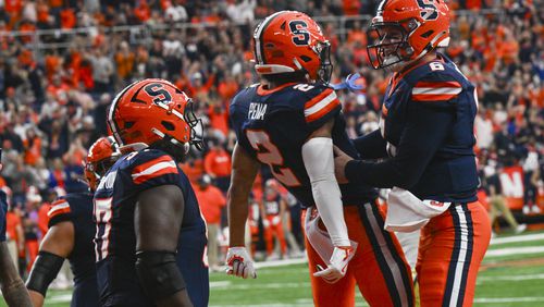 Syracuse wide receiver Trebor Pena (2) and quarterback Kyle McCord (6) celebrate a touchdown with teammates during the first half of an NCAA football game against Georgia Tech, Saturday, Sept. 7, 2024, in Syracuse, N.Y. (AP Photo/Hans Pennink)