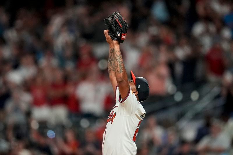 Atlanta Braves reliever Raisel Iglesias (26) celebrates the last stike after the nineth inning of a baseball game against the Philadelphia Phillies, Thursday, Aug. 22, 2024, in Atlanta. (AP Photo/Mike Stewart)