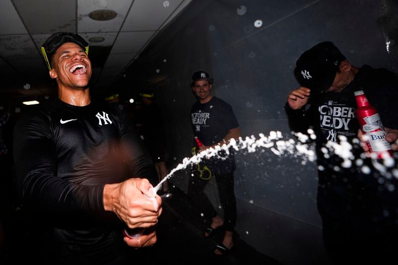 New York Yankees right fielder Juan Soto celebrates clinching a playoff spot after a 2-1 win in 10 innings over the Seattle Mariners in a baseball game Wednesday, Sept. 18, 2024, in Seattle. (AP Photo/Lindsey Wasson)