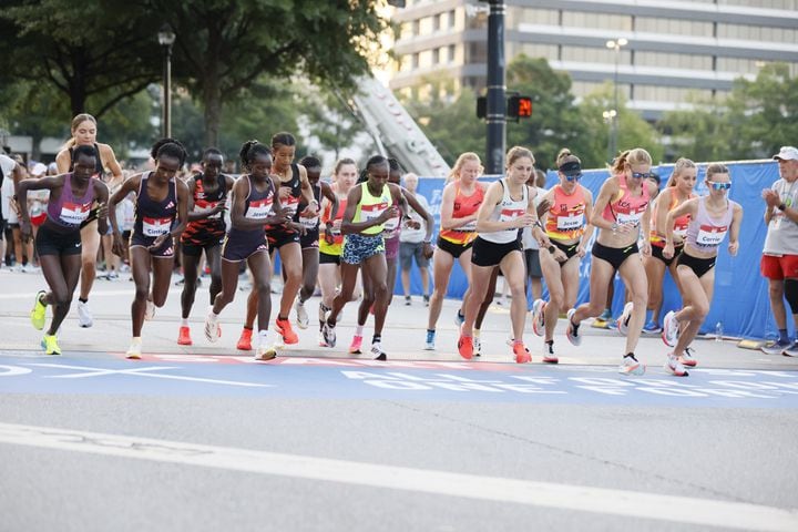 Women elite runners take off at the start of the 55th running of the Atlanta Journal-Constitution Peachtree Road Race in Atlanta on Thursday, July 4, 2024.   (Miguel Martinez / AJC)