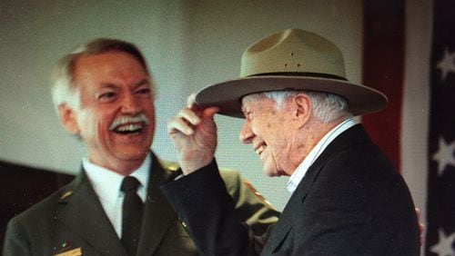 National Park Service director Jonathan B. Jarvis gives Jimmy Carter his very own iconic ranger hat Sunday during a ceremony in Plains where the former president was made an honorary national park ranger. Photo by Jill Stuckey