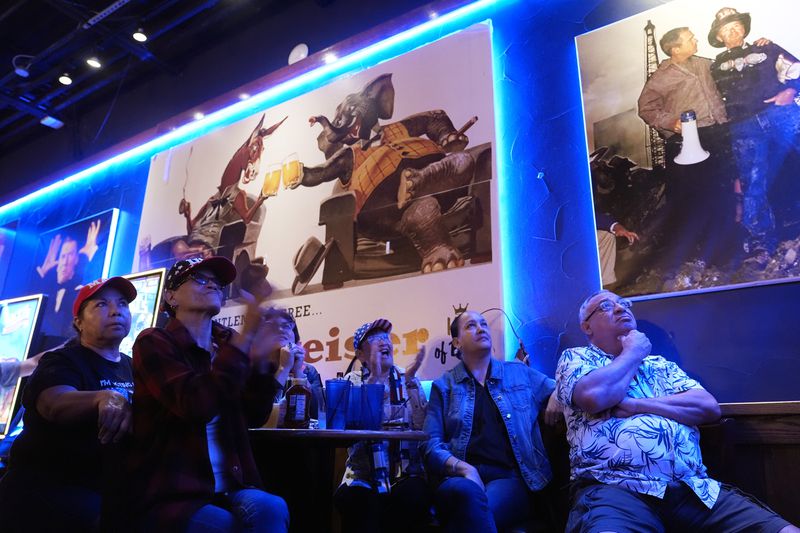 Monica Alvarez, second from left, joins other viewers gathered to watch a debate between Democratic presidential nominee Vice President Kamala Harris and Republican presidential nominee former President Donald Trump at the Angry Elephant Bar and Grill, Tuesday, Sept. 10, 2024, in San Antonio. (AP Photo/Eric Gay)