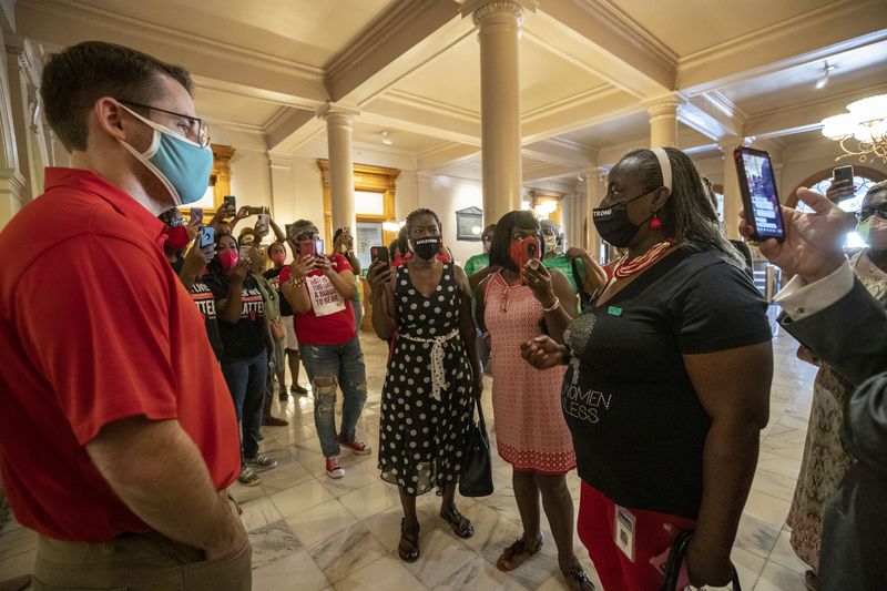 Georgia Rep. Sandra Scott, D-Rex, (right) speaks with Cody Hall (left), press secretary for Gov. Brian Kemp, during a solidarity protest to show support for Atlanta Mayor Keisha Lance Bottoms at the Georgia State Capitol Building on Thursday, July 23, 2020. (ALYSSA POINTER / ALYSSA.POINTER@AJC.COM)