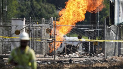 An above-ground valve continues to burn three days after after a vehicle drove through a fence along a parking lot and struck the site, Wednesday, Sept. 18, 2024, in La Porte, Texas. (Jason Fochtman/Houston Chronicle via AP)