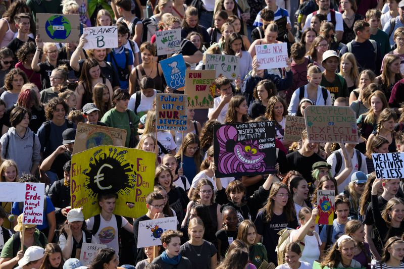 Students hold placards as they take part in a Global Climate Strike protest, part of the Fridays For Future movement, near the chancellery in Berlin, Germany, Friday, Sept. 20, 2024. (AP Photo/Markus Schreiber)