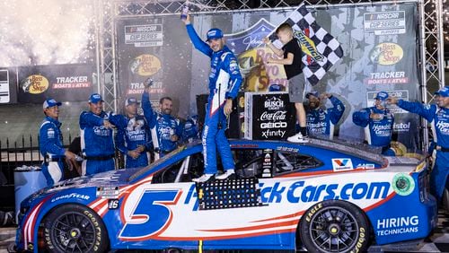 Kyle Larson, center, celebrates with his son Owen after winning a NASCAR Cup Series auto race, Saturday, Sept. 21, 2024, in Bristol, Tenn. (AP Photo/Wade Payne)