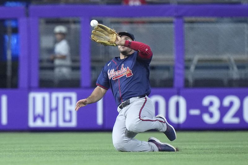 Atlanta Braves left fielder Ramón Laureano catches a ball hit by Miami Marlins' Jesús Sánchez during the fourth inning of a baseball game, Sunday, Sept. 22, 2024, in Miami. (AP Photo/Wilfredo Lee)