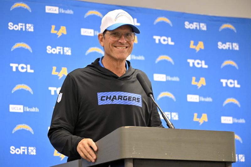 Los Angeles Chargers head coach Jim Harbaugh responds to questions during a news conference after the team's preseason NFL football game against the Dallas Cowboys, Saturday, Aug. 24, 2024, in Arlington, Texas. (AP Photo/Jerome Miron)