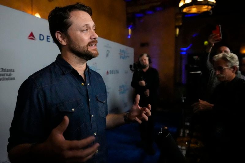 Jason Carter, grandson of President Jimmy Carter, speaks ahead of a "Jimmy Carter 100: A Celebration in Song," concert at the Fox Theatre, Tuesday, Sept. 17, 2024, in Atlanta. (AP Photo/Mike Stewart)