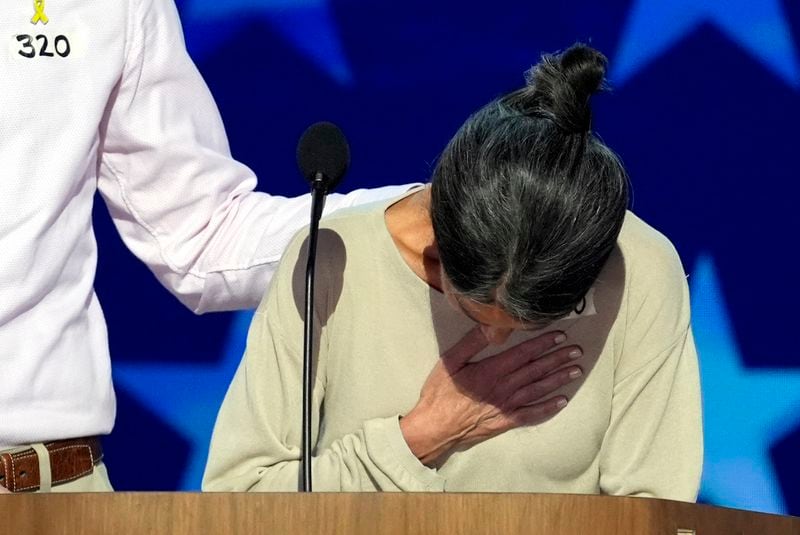 Jon Polin, left, and Rachel Goldberg, parents of Hersh Goldberg-Polin, appear on stage during the Democratic National Convention Wednesday, Aug. 21, 2024, in Chicago. (AP Photo/J. Scott Applewhite)