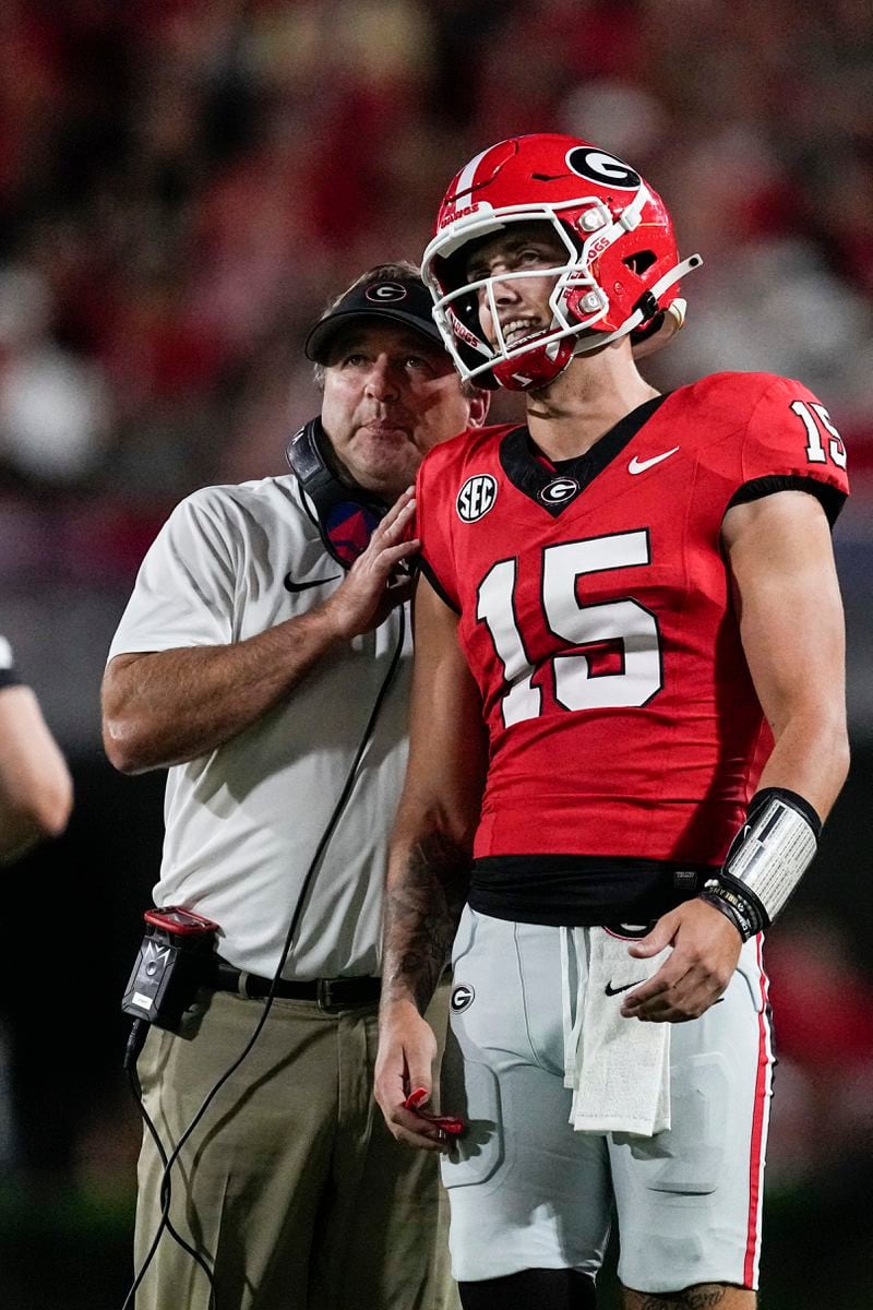 FILE - Georgia head coach Kirby Smart talks with his quarterback Carson Beck during the first half of an NCAA college football game against UAB, Saturday, Sept. 23, 2023, in Athens, Ga. (AP Photo/John Bazemore, File)