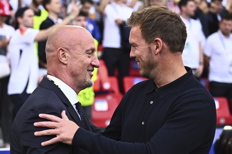 Germany's head coach Julian Nagelsmann, right, greets Hungary's coach Marco Ross, left, before a Group A match between Germany and Hungary at the Euro 2024 soccer tournament in Stuttgart, Germany, Wednesday, June 19, 2024. (Tom Weller/dpa via AP)