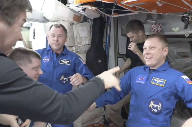 In blue suits, NASA’s Nick Hague, left, and the Russian Space Agency’s Alexander Gorbunov enter the International Space Station from the SpaceX capsule Dragon, Sunday, Sept. 29, 2024. (NASA via AP)