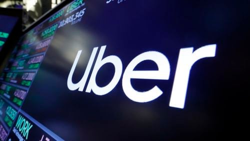 FILE - The Uber logo appears above a trading post on the floor of the New York Stock Exchange, Aug. 16, 2019. The ride sharing giant Uber and Chinese automaker BYD plan a partnership to introduce 100,000 BYD model EVs on the Uber platform in Europe and Latin America, eventually expanding to other markets, the companies announced. (AP Photo/Richard Drew, File)