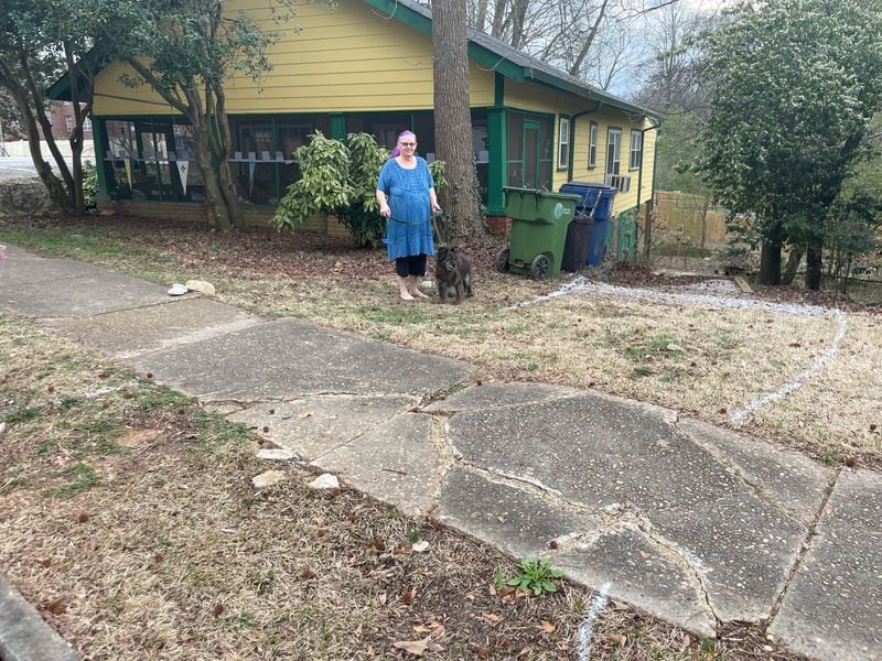 Kristine Seelye-King, a resident on United Avenue in southeast Atlanta, shows the lines where a driveway will have to be built. “I’m told I need a permit for a curb cut, a permit for the driveway, a permit for the right-of-way, an architectural survey and have surveyors do a site map.”