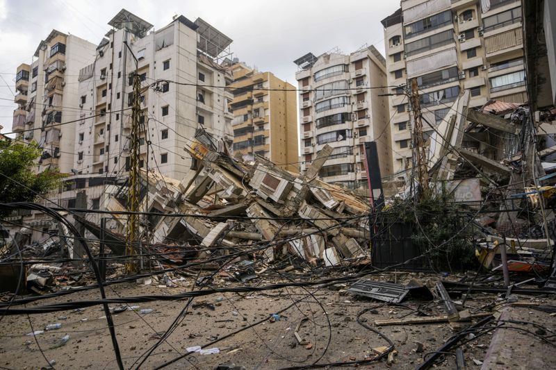 A damaged building is seen at the site of an Israeli airstrike in Beirut's southern suburb, Lebanon, Tuesday, Oct. 1, 2024. (AP Photo/Hassan Ammar)