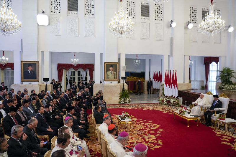 Pope Francis and Indonesian President Joko Widodo, right, attend a meeting with Indonesian authorities and Ambassadors at Istana Merdeka Presidential Palace in Jakarta, Wednesday, Sept. 4, 2024. Pope Francis is opening his visit to Indonesia with a meeting at the presidential palace where he is expected to press his hopes for continued interfaith harmony in a country with a tiny Catholic minority and the world's largest Muslim population.(AP Photo/Gregorio Borgia)