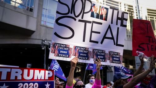 FILE - President Donald Trump supporters gather with some signs claiming a stolen election outside the Philadelphia Convention Center as they await general election tabulation results, Nov. 6, 2020, in Philadelphia. (AP Photo/John Minchillo, File)