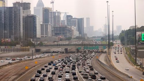 Automobiles travel along the I-75 / I-85 connector shown from the 17th street bridge looking south, Friday, June 30, 2023, in Atlanta. The Georgia Department of Natural Resources, Environmental Protection Division has issued a Code Orange Air Quality alert for Atlanta for Friday June 30th. Jason Getz / Jason.Getz@ajc.com)