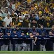 Members to the Atlanta Braves watch from the dugout during the ninth inning in Game 2 of an NL Wild Card Series baseball game against the San Diego Padres, Wednesday, Oct. 2, 2024, in San Diego. (AP Photo/Gregory Bull)