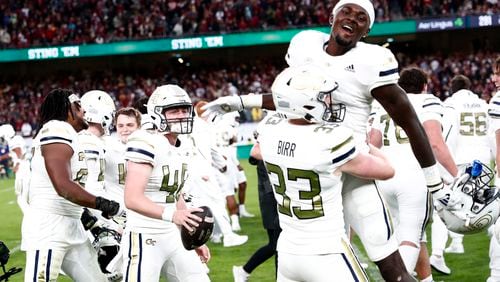 Georgia players celebrate after the NCAA college football game between Georgia Tech and Florida State at the Aviva stadium in Dublin, Saturday, Aug. 24, 2024. (AP Photo/Peter Morrison)