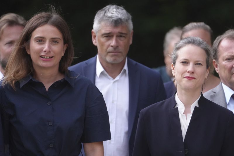 Marine Tondelier, left, leader of the Green Party, and Lucie Castets, right, the New Popular Front coalition's choice for prime minister, arrive at the Elysee Palace as French President Emmanuel Macron holds talks with key political players in a bid to form a new government Friday, Aug. 23, 2024 in Paris. (AP Photo/Thibault Camus)