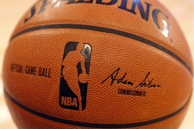 FILE - An NBA logo is seen on an official game ball before a basketball game, Feb. 1, 2014, in New York. The NBA said Wednesday, July 24, 2024, that it is not accepting Warner Bros. Discovery's $1.8 billion per year offer to continue its longtime relationship with the league and therefore has entered into a deal with Amazon Prime Video, a move that would mean this coming season would end a nearly four-decade run of games being on TNT. (AP Photo/Jason DeCrow, file)