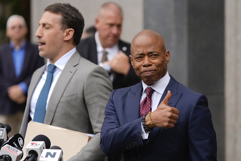 New York City mayor Eric Adams, right, appears with his attorney, Alex Spiro, outside Manhattan federal court after an appearance, Friday, Sept. 27, 2024, in New York. (AP Photo/Julia Demaree Nikhinson)