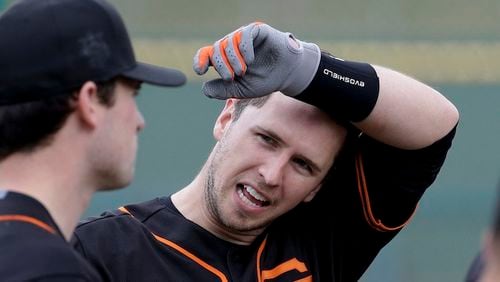 San Francisco Giants catcher Buster Posey talks during batting practice during the spring baseball season in Scottsdale, Ariz., Thursday, Feb. 18, 2016. (AP Photo/Chris Carlson)