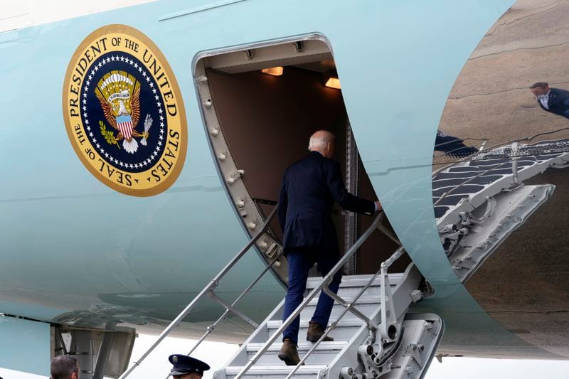 President Joe Biden walks up the steps and boards Air Force One at Joint Base Andrews, Md., Wednesday, Oct. 2, 2024, as he heads to North and South Carolina to survey damage from Hurricane Helene. (AP Photo/Susan Walsh)