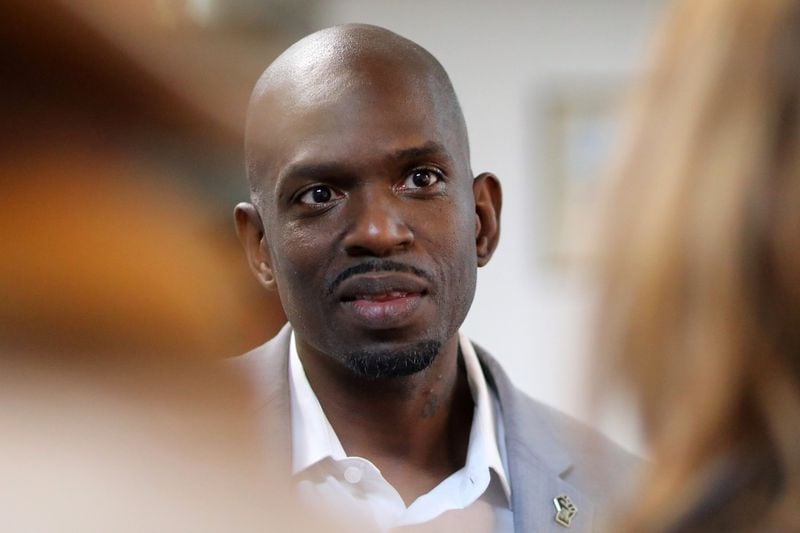 South Fulton mayor-elect Khalid Kamau speaks with Old National Merchants Association members during a toy drive on Thursday, December 9, 2021. Miguel Martinez / The Atlanta Journal-Constitution