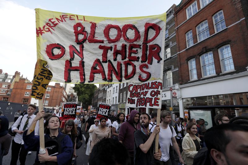 FILE - People gather outside Kensington Town Hall during protests following the Grenfell Tower fire in London, Friday June 16, 2017. (AP Photo/Tim Ireland, File)